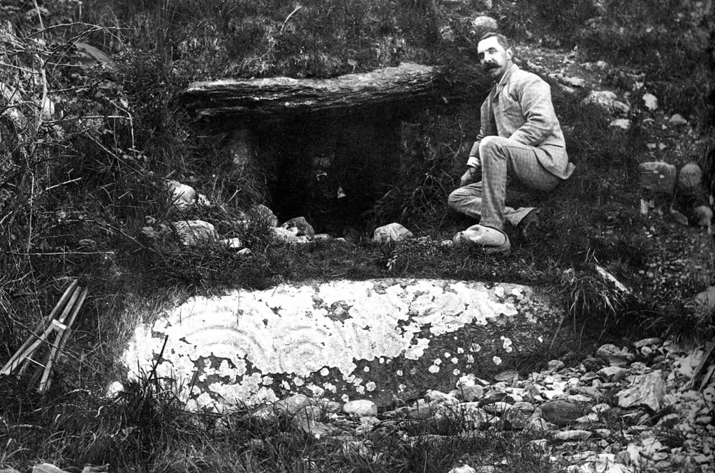 Late nineteenth-century photograph of Newgrange showing the entrance passage and surrounding kerbstones before excavation.