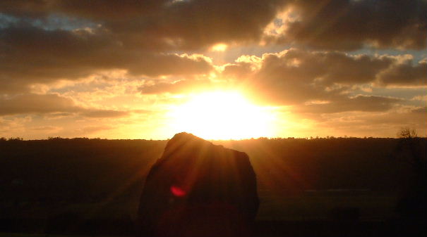 Sunrise over a standing stone at Newgrange.